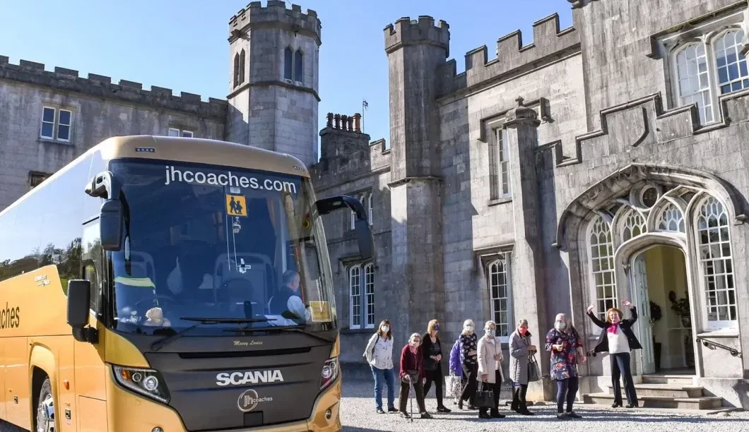 Coach outside stately home